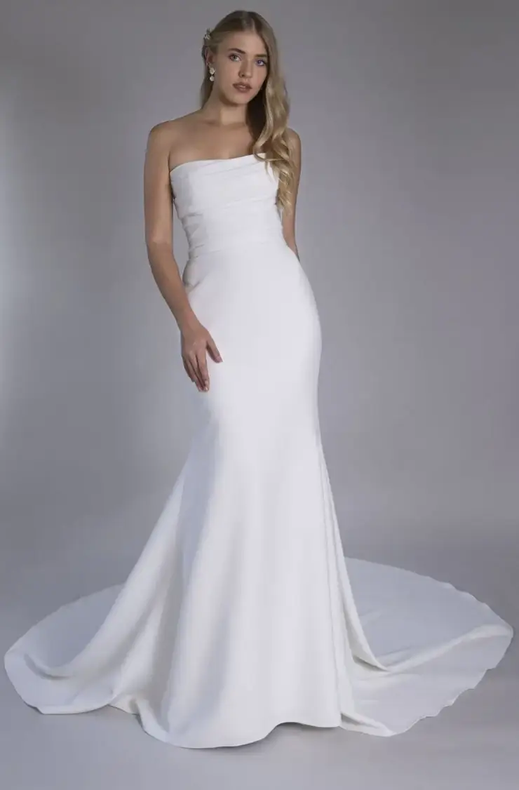 model is wearing a strapless fit and flare bridal gown