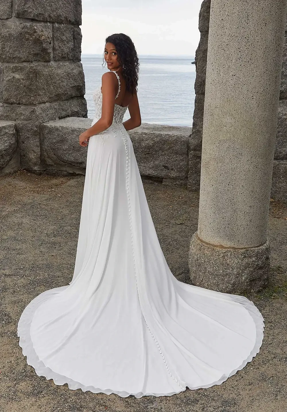 model is wearing a sleeveless breezy a-line gown